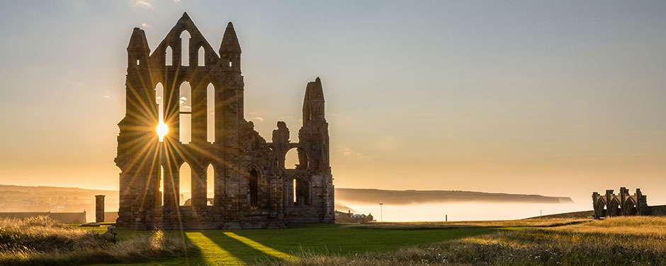 Sunset over the Whitby Abbey ruins in England
